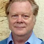 Portrait of a middle-aged man with light hair and blue eyes.