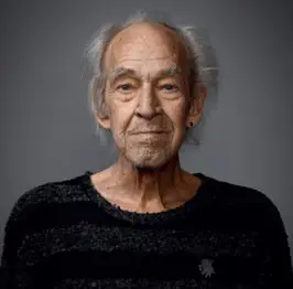 Portrait of an elderly man with a gentle expression and gray hair.