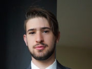 Relational Psychoanalysis and Psychotherapy Integration Young man in a suit with a blue tie looking at the camera.