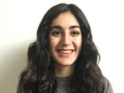 Trauma and Memory: Brain and Body in a Search for the Living Past Smiling young woman with long curly hair wearing a gray shirt.