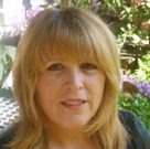 The Handbook of Body Psychotherapy and Somatic Psychology: A Day Long Celebration A woman with blonde hair and bangs outdoors.