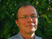 The Handbook of Body Psychotherapy and Somatic Psychology: A Day Long Celebration Man in striped shirt with leafy background.
