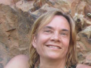 We are the Movement Smiling woman with blonde hair poses outdoors against a rocky background.