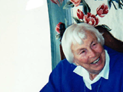 The Treasure and the Tragedy of Wilhelm Reich Elderly woman smiling beside a birthday cake with candles.