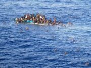 Children of Refugees Overcrowded boat in the ocean with people.