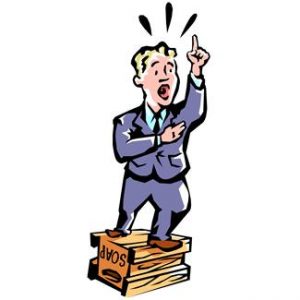 Man giving speech on stacked soapboxes.