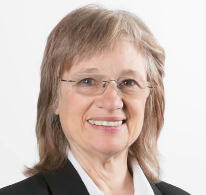 Different Strokes for Different Folks: The BodyMind Approach as a Learning Tool for Patients with Medically Unexplained Symptoms to Self-Manage Professional portrait of a smiling older woman in business attire.