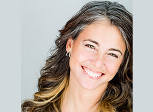 It’s Never Too Late: Healing Prebirth and Birth at Any Age – A Reflection by Mia Kalef DC Smiling woman with wavy hair in a casual top.