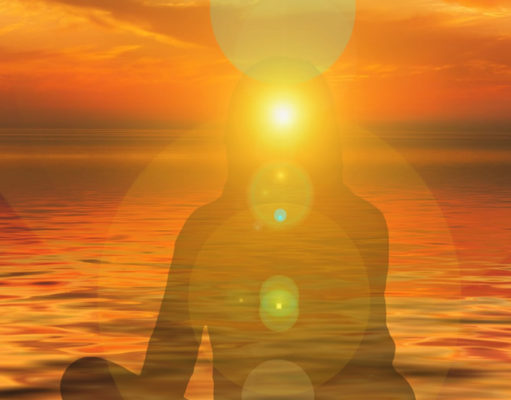 Listening to Your Body: How to Include the Body in a Therapeutic Conversation Silhouette of a person meditating at sunset over the ocean.