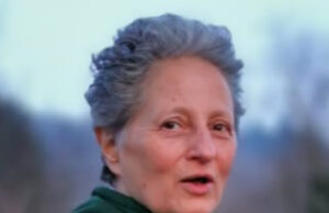 When The Past Floods The Present: Regression, Flashbacks, and the Art of Coming Home Person outdoors with short gray hair, green hoodie