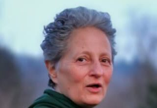 When The Past Floods The Present: Regression, Flashbacks, and the Art of Coming Home Person outdoors with short gray hair, green hoodie